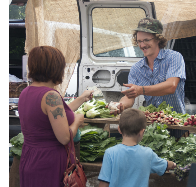 farmer and customer interactions at Asheville City Market, photo by Sarah Jones Decker